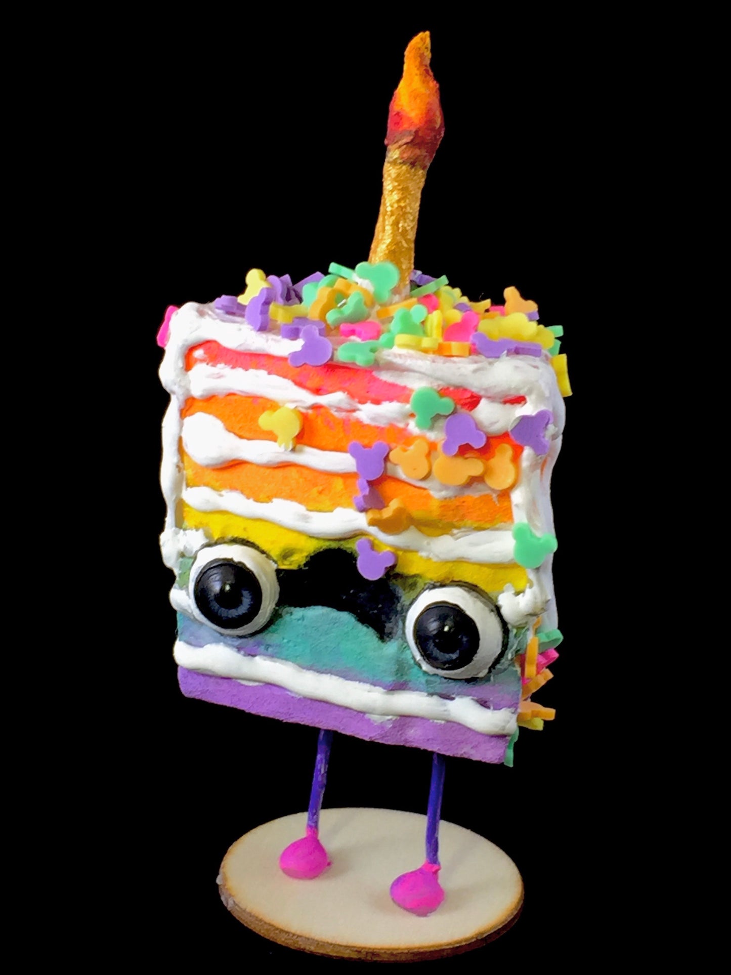 Rainbow Spun Cotton Cake figurine with white frosting