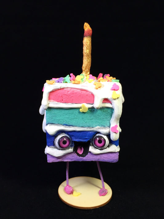 Rainbow Spun Cotton Cake figurine with white frosting