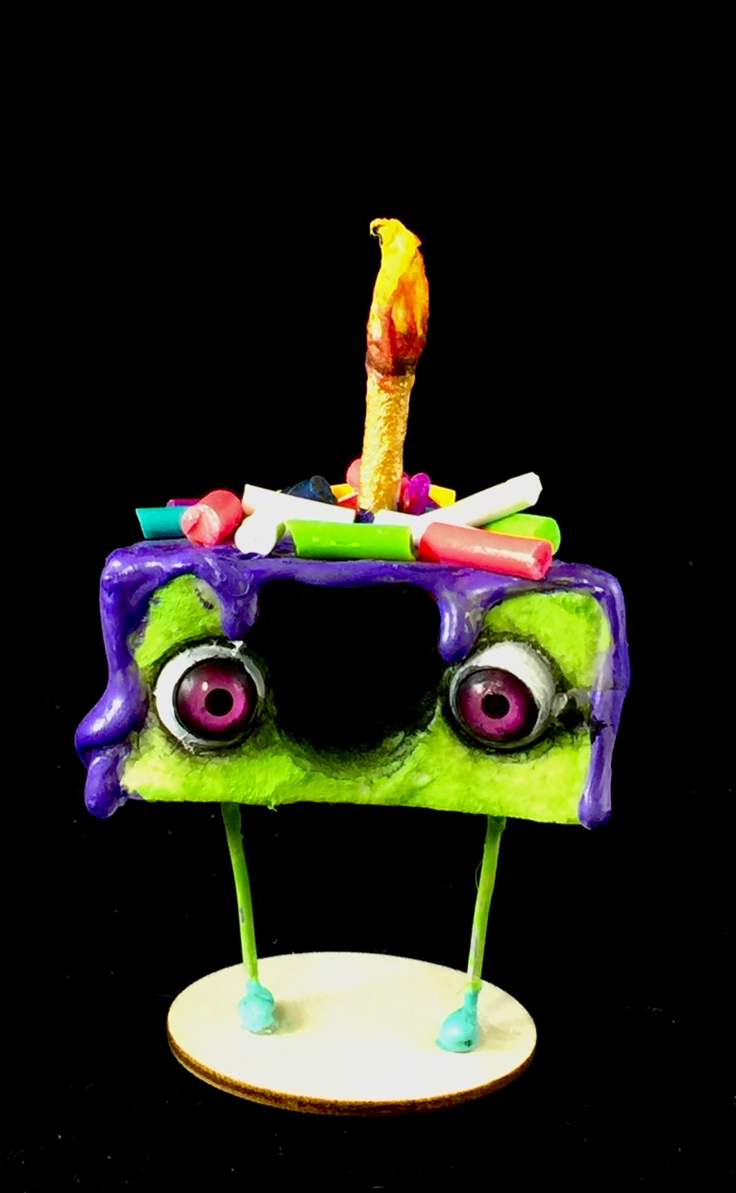 Green Spun Cotton Cake figurine with Purple frosting